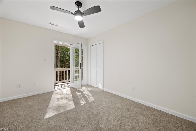 spare room with carpet flooring and ceiling fan