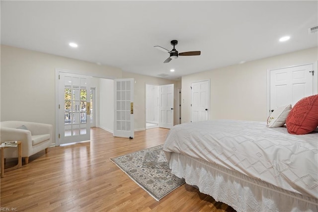 bedroom featuring access to exterior, ceiling fan, light hardwood / wood-style flooring, and french doors