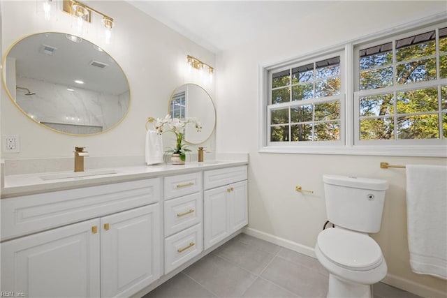 bathroom with tile patterned flooring, vanity, and toilet