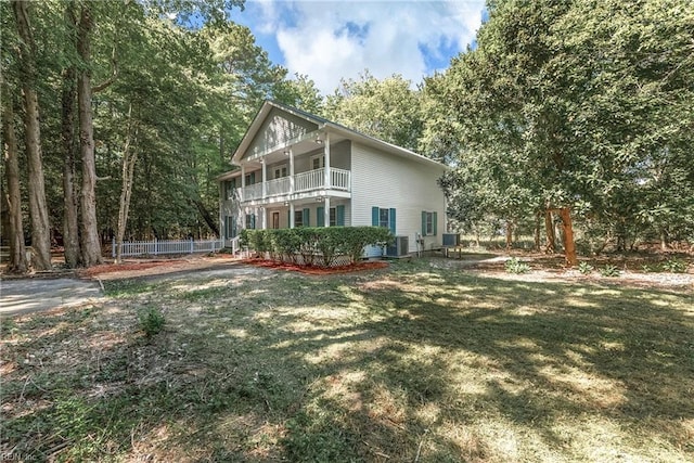 view of property exterior with a yard and a balcony