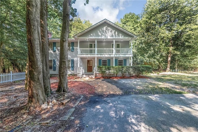 view of front of house with covered porch and a balcony