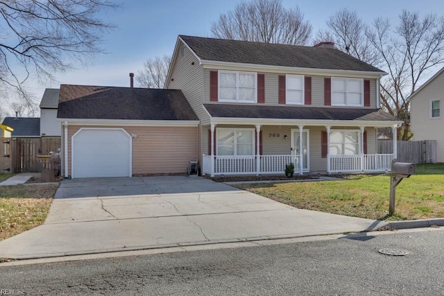 view of front of house with covered porch, a garage, and a front yard