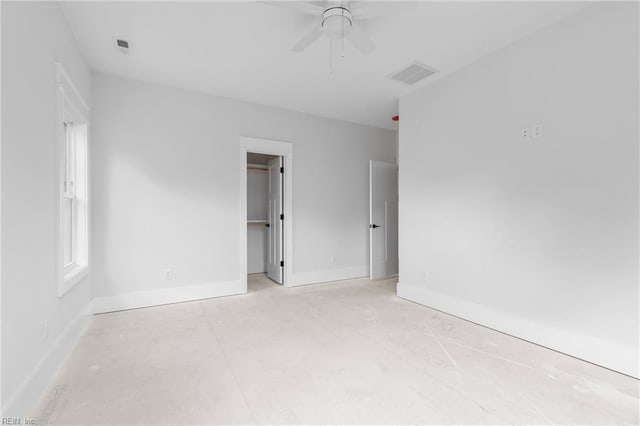 spare room featuring plenty of natural light and ceiling fan