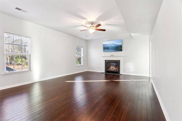 unfurnished living room with ceiling fan and dark hardwood / wood-style floors