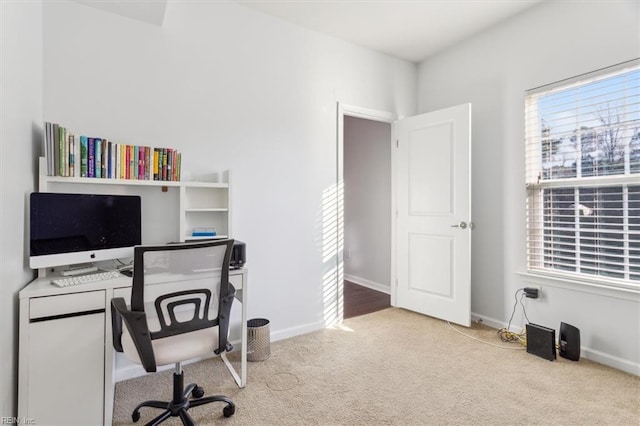 carpeted home office featuring a healthy amount of sunlight