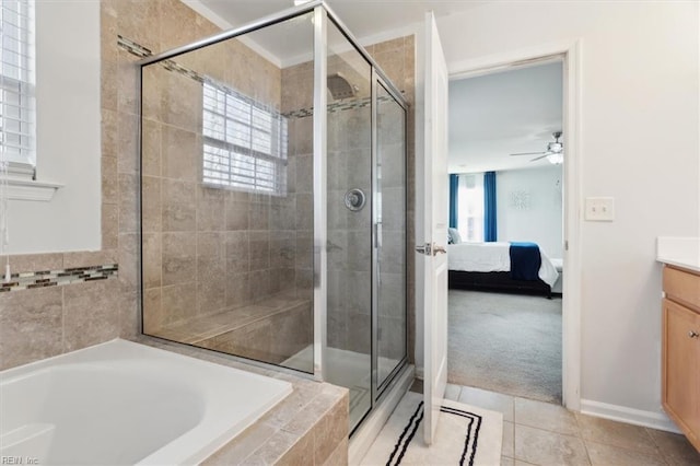 bathroom featuring tile patterned floors, a wealth of natural light, vanity, and ceiling fan