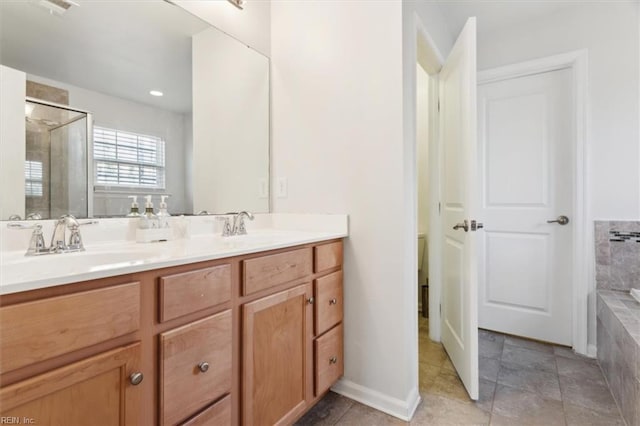 bathroom with vanity and shower with separate bathtub