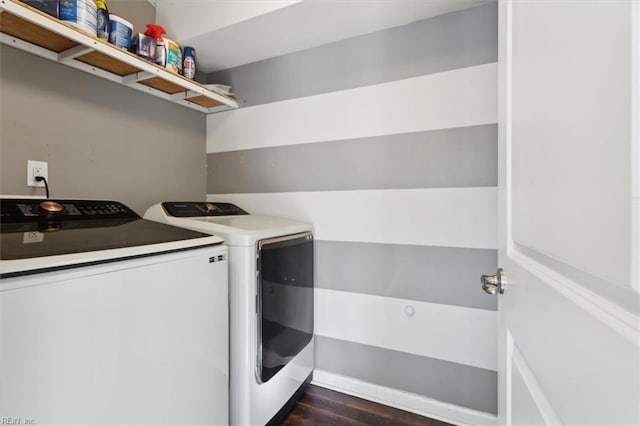 clothes washing area featuring washing machine and dryer and dark wood-type flooring