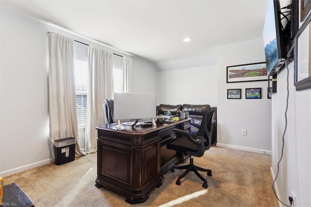 carpeted home office featuring lofted ceiling