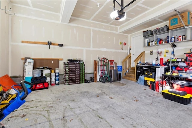 garage with a workshop area and a garage door opener