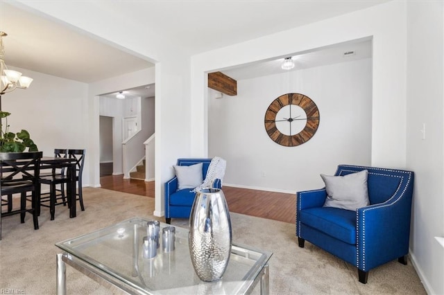 living area featuring a chandelier and light colored carpet