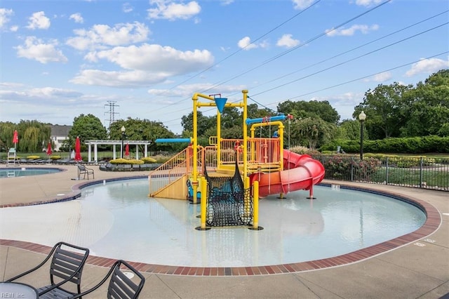 view of playground featuring a community pool