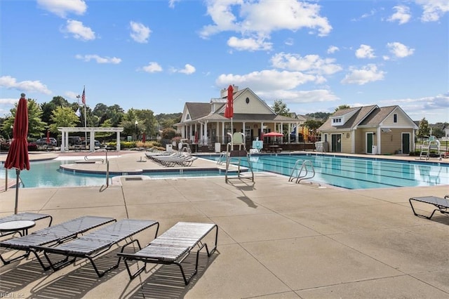 view of pool featuring a pergola, a patio, and an outdoor structure