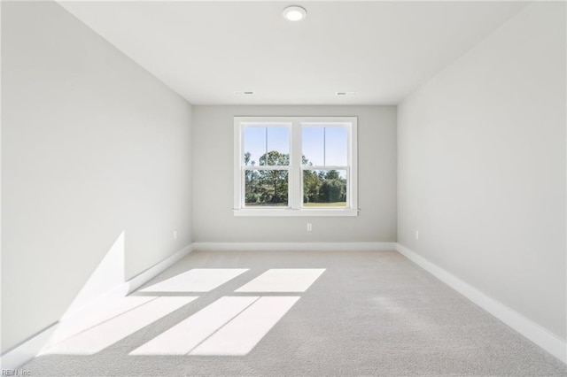 unfurnished room featuring light carpet