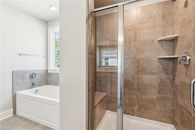 bathroom featuring tile patterned flooring and shower with separate bathtub