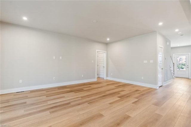 empty room with light hardwood / wood-style floors