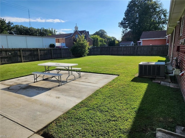 view of yard with central air condition unit and a patio