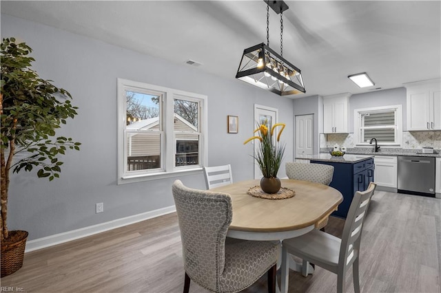 dining area featuring hardwood / wood-style floors and sink