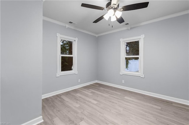 spare room featuring light wood-type flooring, ceiling fan, and crown molding