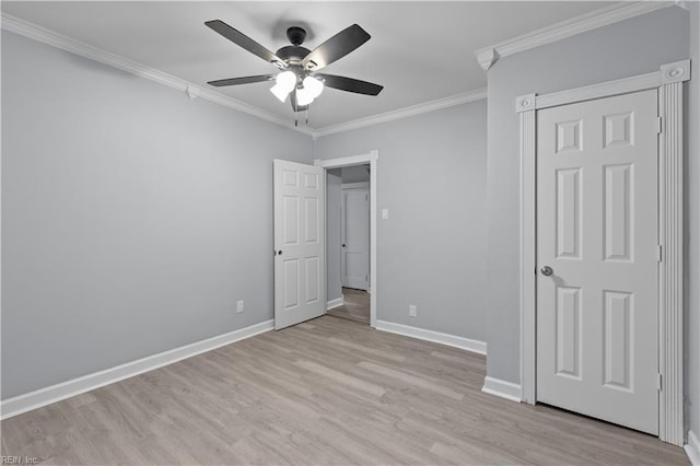 unfurnished bedroom featuring ceiling fan, light wood-type flooring, and ornamental molding