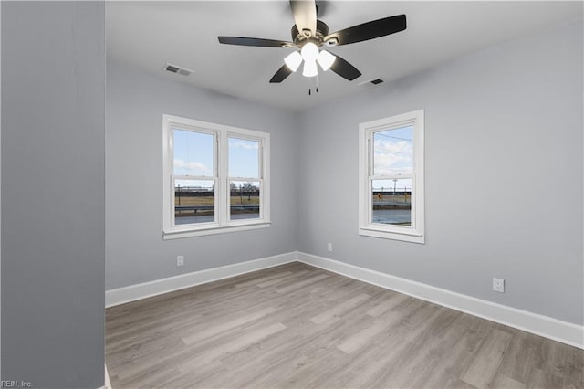 spare room with light hardwood / wood-style floors and ceiling fan