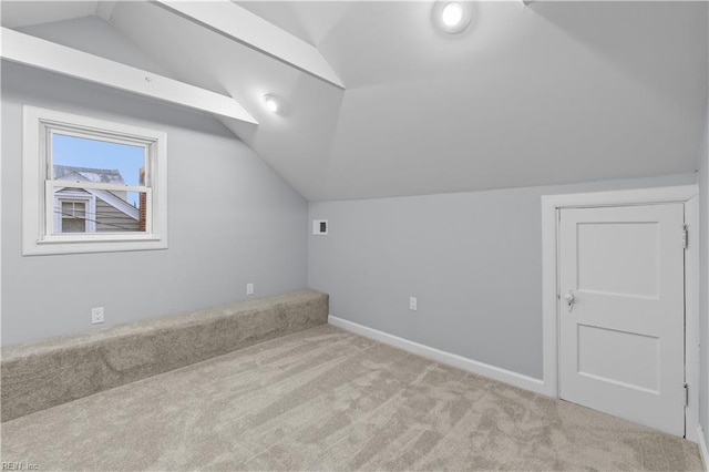 bonus room featuring light colored carpet and lofted ceiling