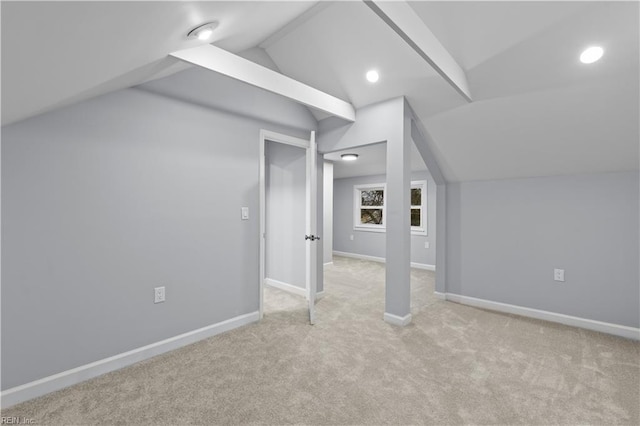 bonus room with light carpet and vaulted ceiling