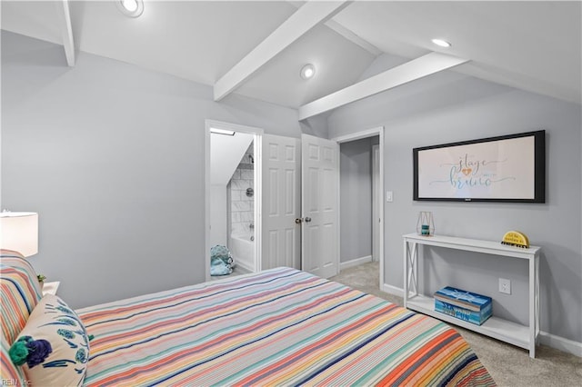 bedroom featuring lofted ceiling with beams, light colored carpet, and ensuite bathroom