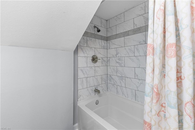 bathroom featuring shower / bath combination with curtain and a textured ceiling