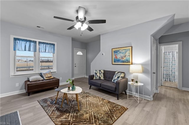 living room with ceiling fan and light hardwood / wood-style floors