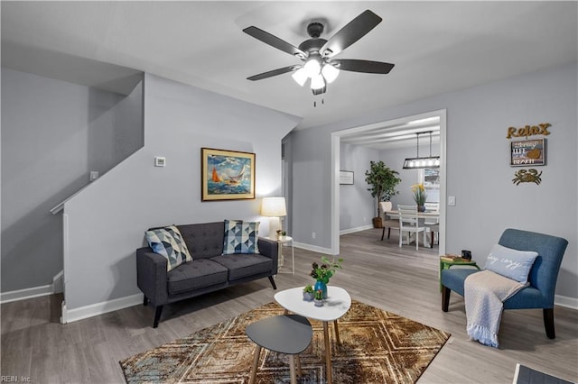 living room with hardwood / wood-style flooring and ceiling fan