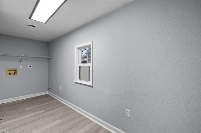 laundry area with electric dryer hookup, washer hookup, and light hardwood / wood-style floors