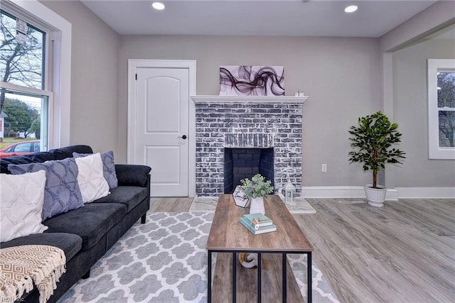 living room featuring a fireplace and light hardwood / wood-style flooring