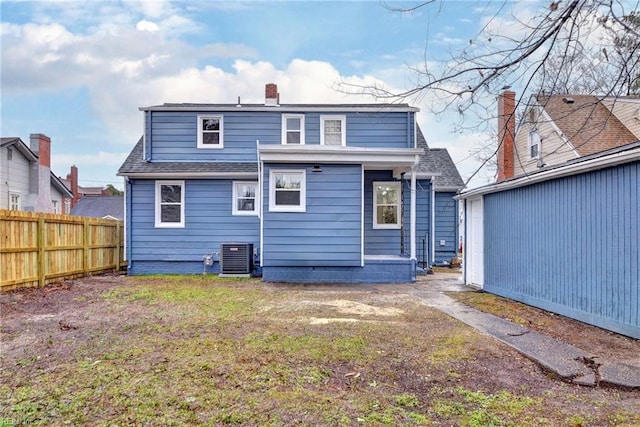 rear view of house with central AC unit