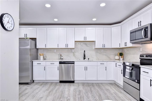 kitchen with white cabinets, stainless steel appliances, and sink