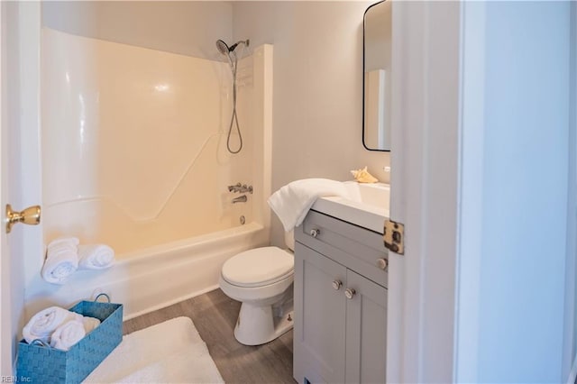 full bathroom with shower / bathing tub combination, toilet, vanity, and hardwood / wood-style flooring