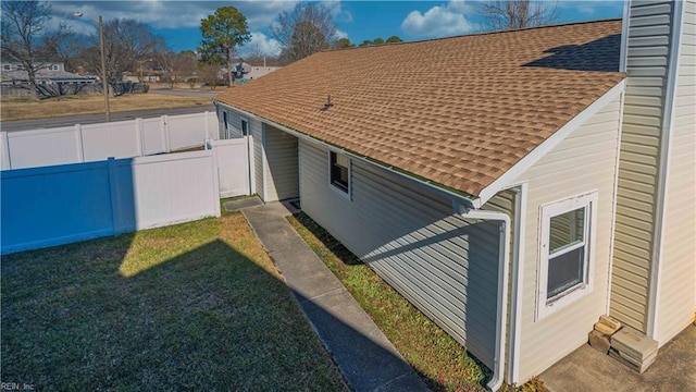 view of side of property with a lawn