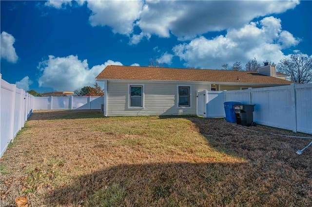 back of house featuring a yard