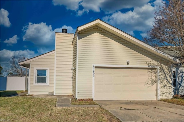 view of side of home with a garage and a lawn