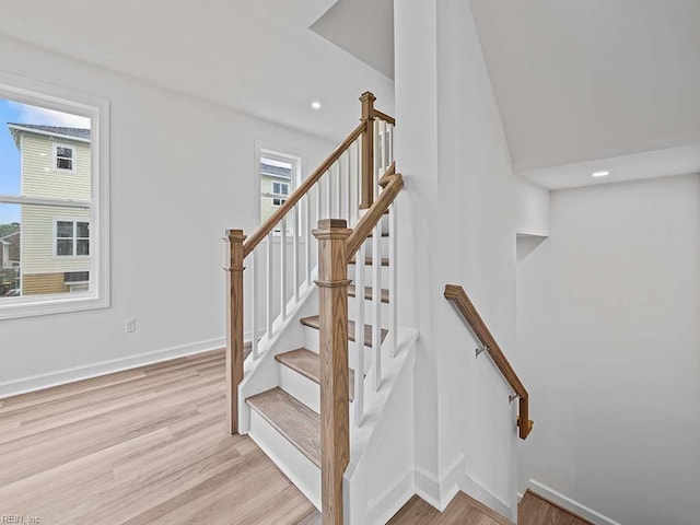 stairway featuring wood-type flooring