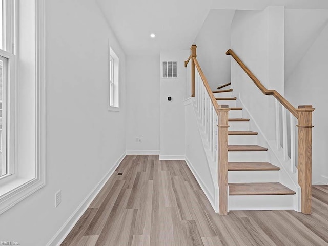 stairs featuring wood-type flooring