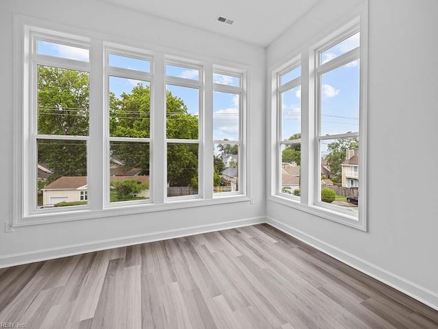 unfurnished sunroom featuring a healthy amount of sunlight