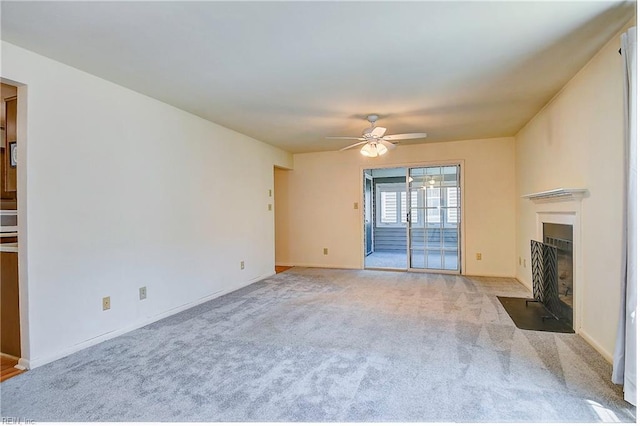 unfurnished living room with light carpet and ceiling fan