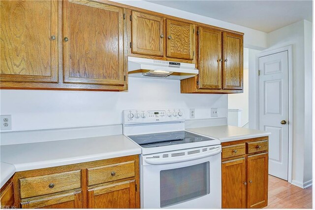 kitchen with light hardwood / wood-style flooring and white electric stove