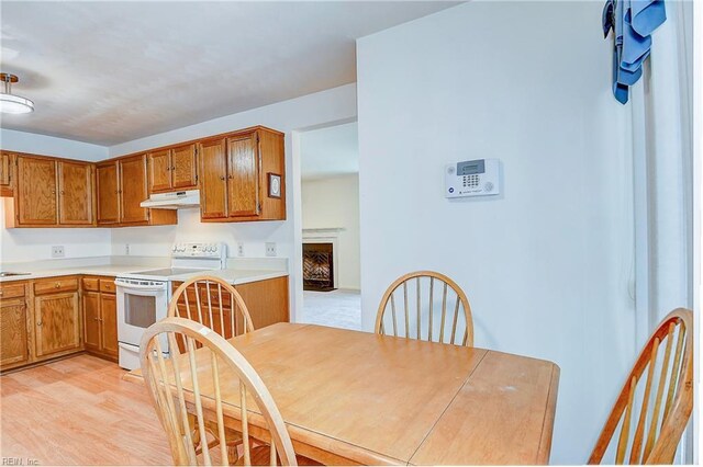 kitchen featuring white range with electric stovetop and light wood-type flooring