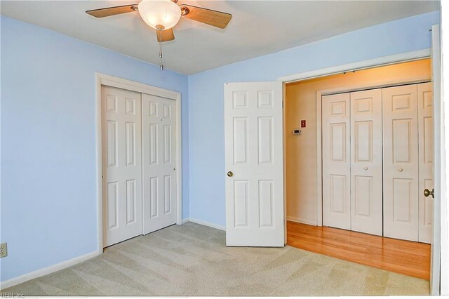 unfurnished bedroom with light colored carpet and ceiling fan