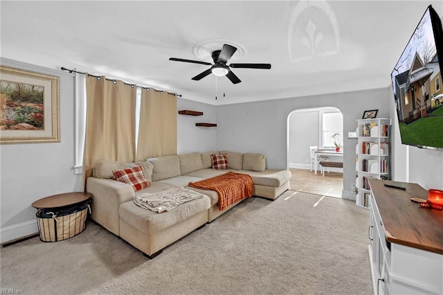 carpeted living room with ceiling fan