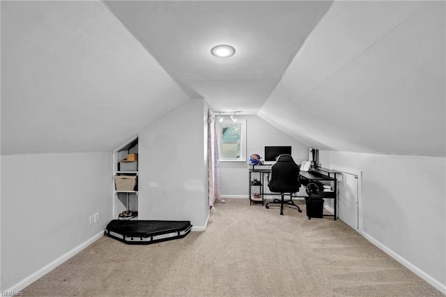 home office featuring carpet and lofted ceiling