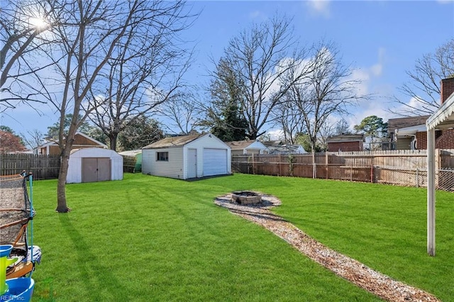 view of yard with a fire pit and a shed