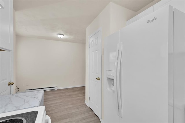 interior space featuring hardwood / wood-style flooring and baseboard heating